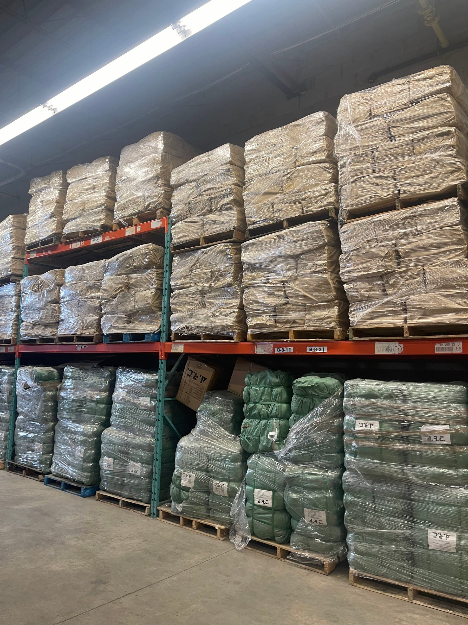 Wrapped bales on two levels of orange racking in our Scarborough warehouse